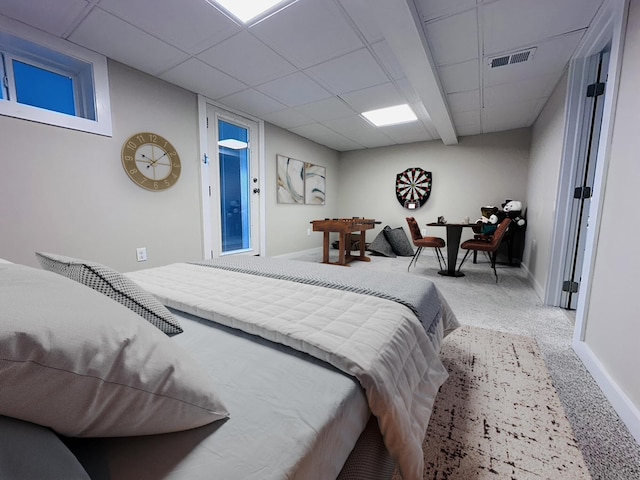 bedroom with a drop ceiling, carpet flooring, visible vents, and baseboards