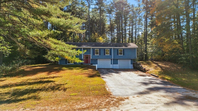 raised ranch with a front yard and a garage