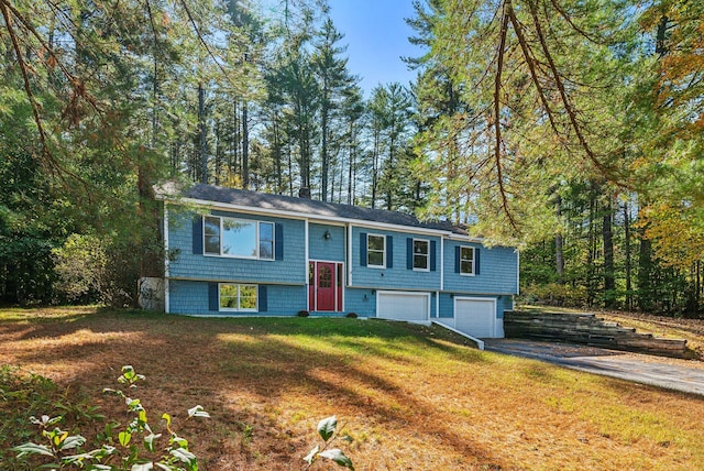 bi-level home with a front lawn and a garage