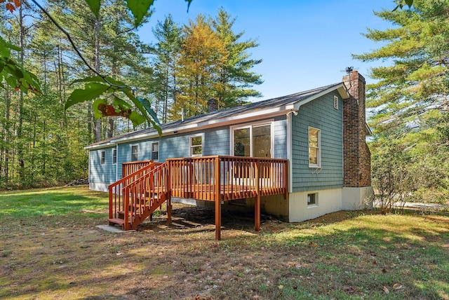 back of property with a lawn and a wooden deck