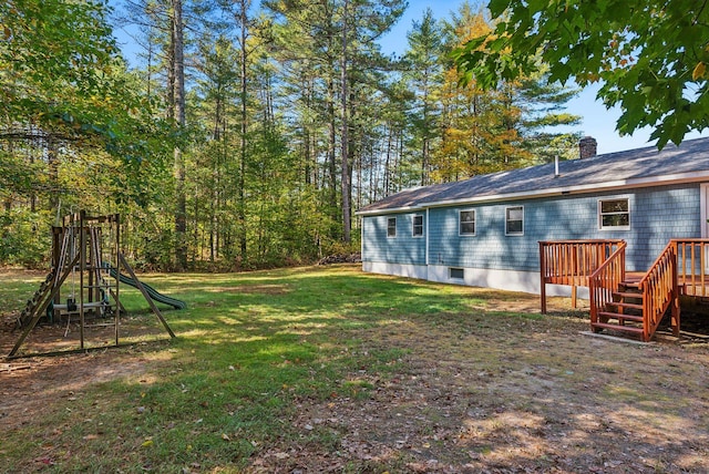 view of yard with a playground and a deck