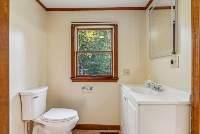 bathroom featuring ornamental molding, toilet, and vanity