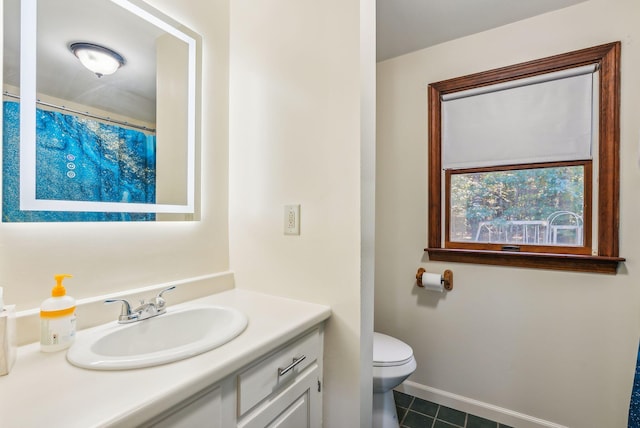 bathroom with vanity, toilet, and tile patterned floors