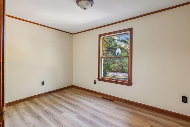 unfurnished room with light wood-type flooring and ornamental molding