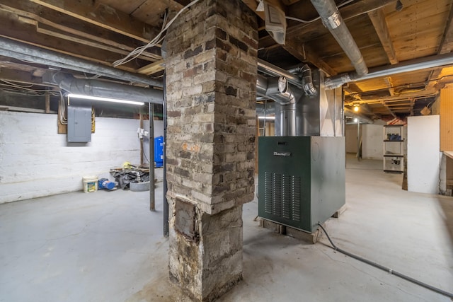 basement featuring electric panel and heating unit