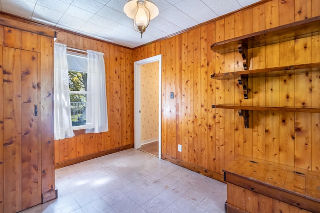 unfurnished room with wood walls