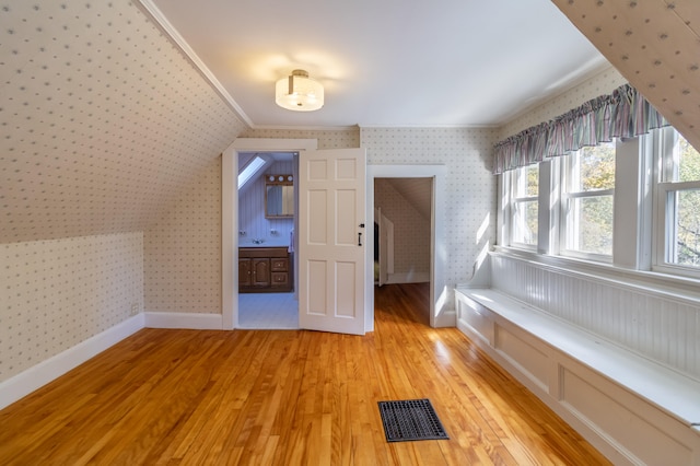 bonus room with light hardwood / wood-style flooring