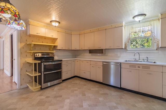 kitchen featuring stainless steel appliances, pendant lighting, decorative backsplash, and sink