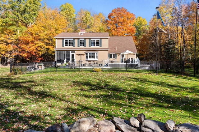 back of house with a lawn