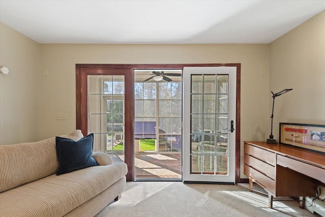 doorway with light carpet and ceiling fan