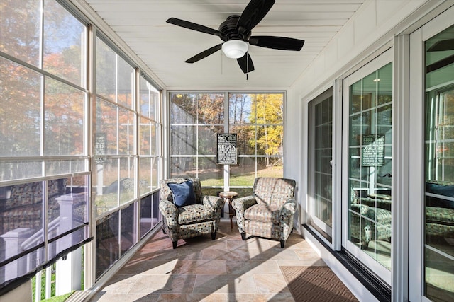 sunroom with a wealth of natural light and ceiling fan