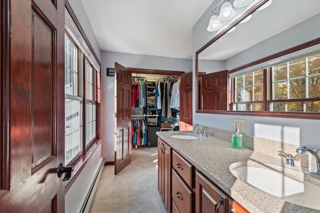 bathroom with vanity and a baseboard heating unit