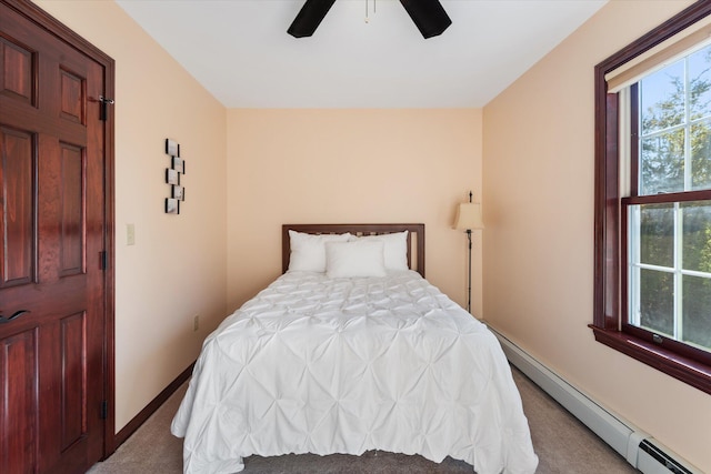 bedroom with ceiling fan, light carpet, and a baseboard heating unit