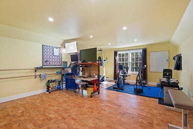 workout room with vaulted ceiling and carpet floors