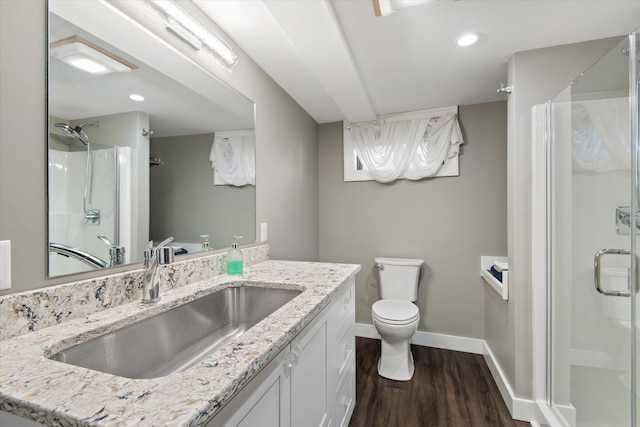 bathroom featuring vanity, hardwood / wood-style floors, toilet, and an enclosed shower