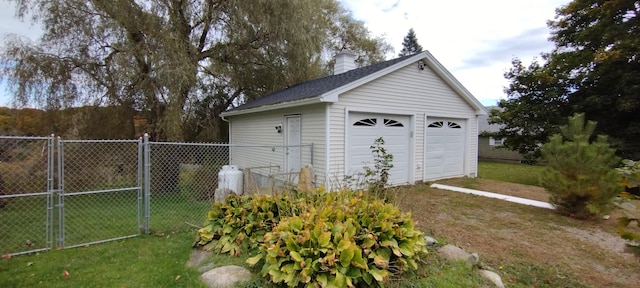 view of outdoor structure featuring a yard and a garage