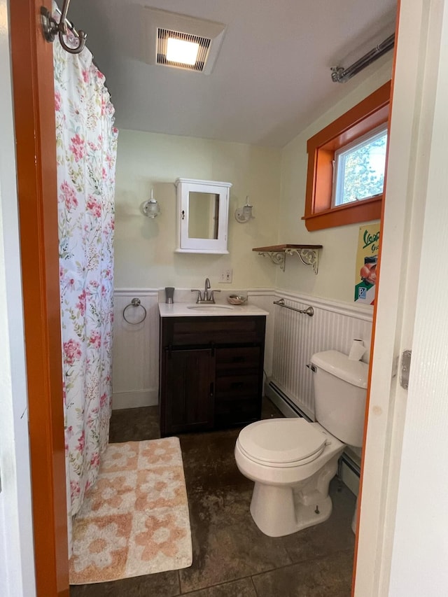 bathroom with tile patterned floors, toilet, a baseboard heating unit, curtained shower, and vanity