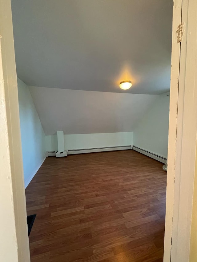 bonus room with lofted ceiling and dark wood-type flooring