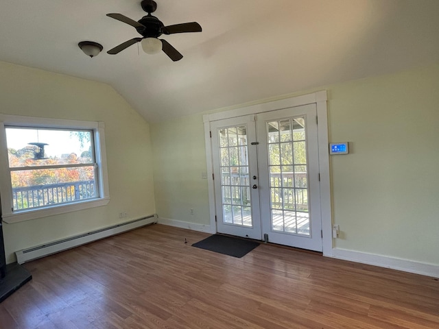 entryway featuring hardwood / wood-style floors, a baseboard radiator, french doors, and vaulted ceiling