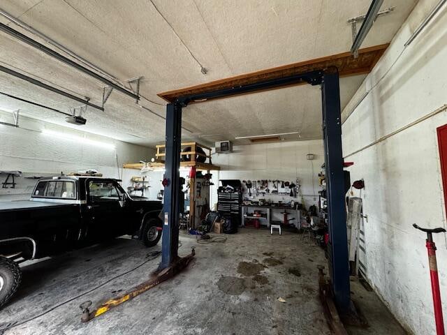 garage with a workshop area and a garage door opener