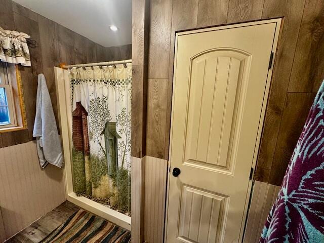 bathroom featuring wooden walls