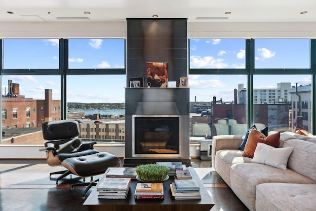 living room featuring a fireplace and concrete floors