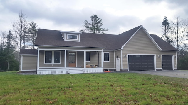 view of front of house with a front lawn, a garage, and a porch