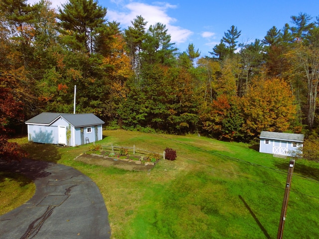 468 Curtis Rd, Swanville, ME 04915 - view of yard with an outbuilding, a view of trees, and a shed