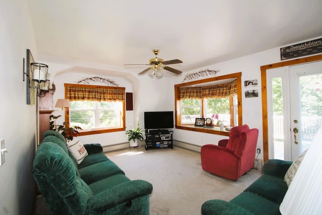 living room with a healthy amount of sunlight, light colored carpet, and a baseboard radiator