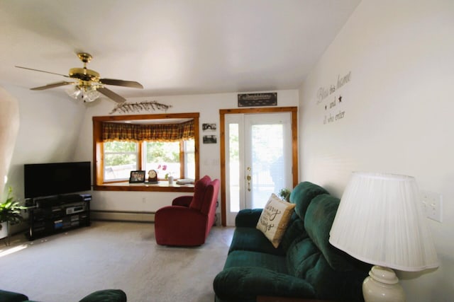 living room featuring a baseboard heating unit, light carpet, a healthy amount of sunlight, and ceiling fan