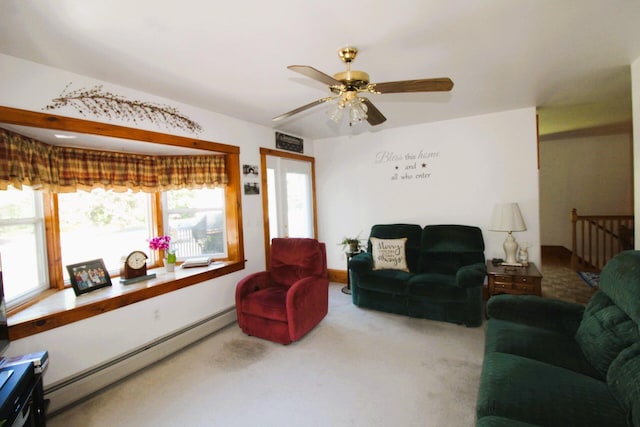 carpeted living room featuring ceiling fan, a healthy amount of sunlight, and baseboard heating