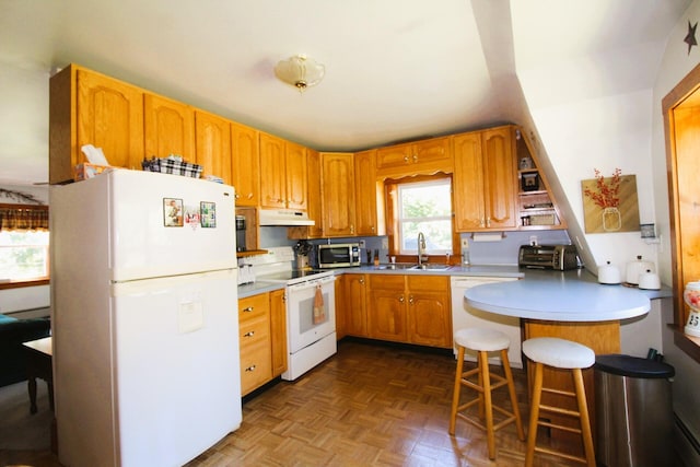 468 Curtis Rd, Swanville, ME 04915 - kitchen with a sink, a peninsula, white appliances, under cabinet range hood, and a kitchen bar
