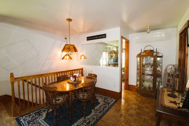 dining room featuring dark parquet floors and a wall mounted AC