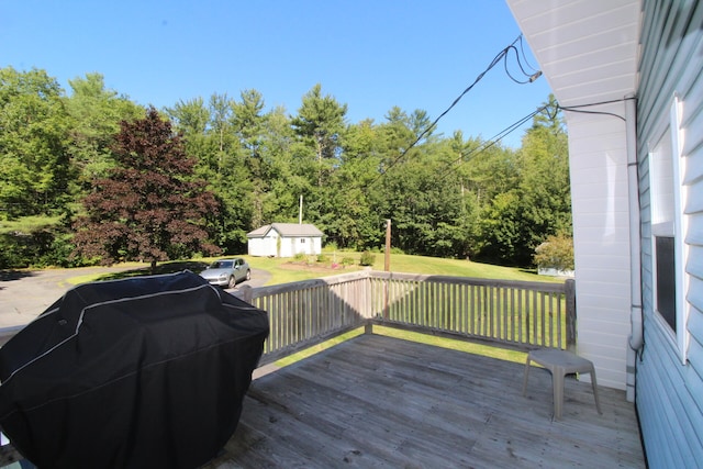 deck with a storage shed, grilling area, and a lawn