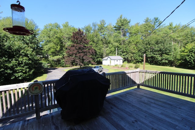 wooden terrace featuring a yard