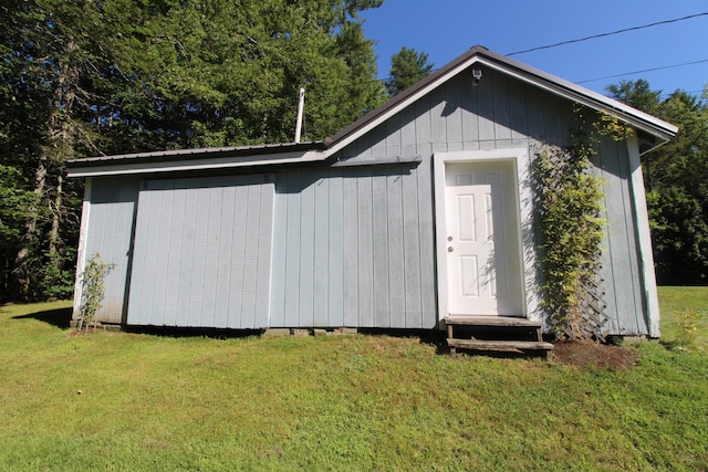 view of outbuilding with a yard