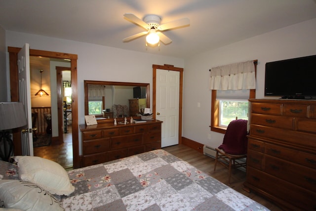 bedroom with wood-type flooring and ceiling fan