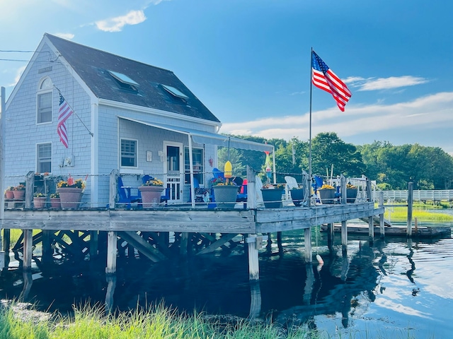 back of property featuring a water view