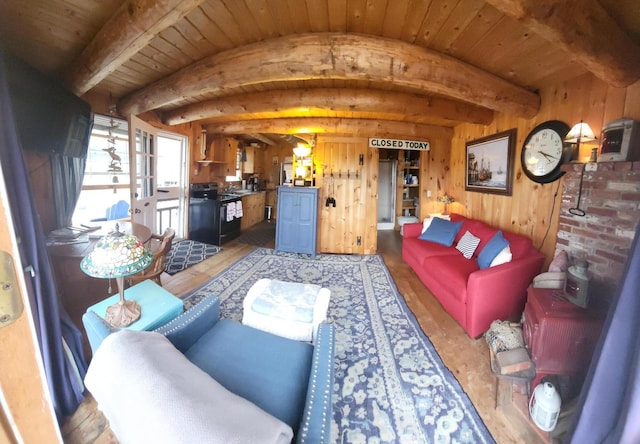 living room with beam ceiling, wooden walls, hardwood / wood-style floors, and wooden ceiling