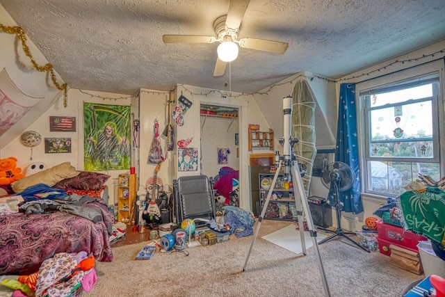 carpeted bedroom featuring ceiling fan, a closet, and a textured ceiling