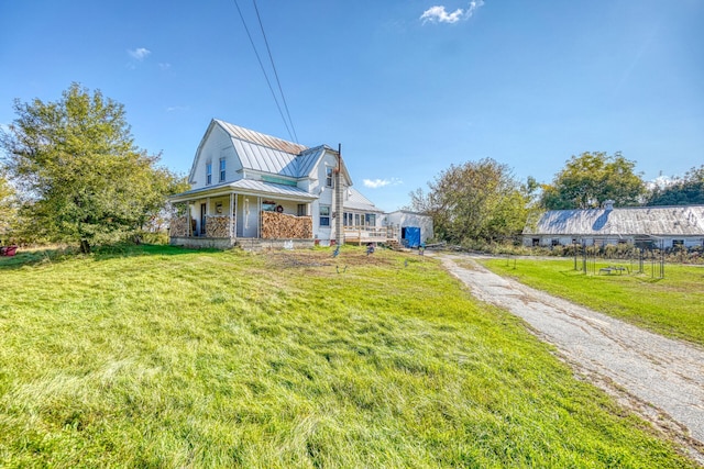 view of property exterior with covered porch and a lawn