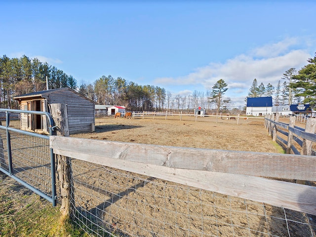 view of yard with an outbuilding and a rural view