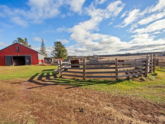 view of yard with an outbuilding and a rural view