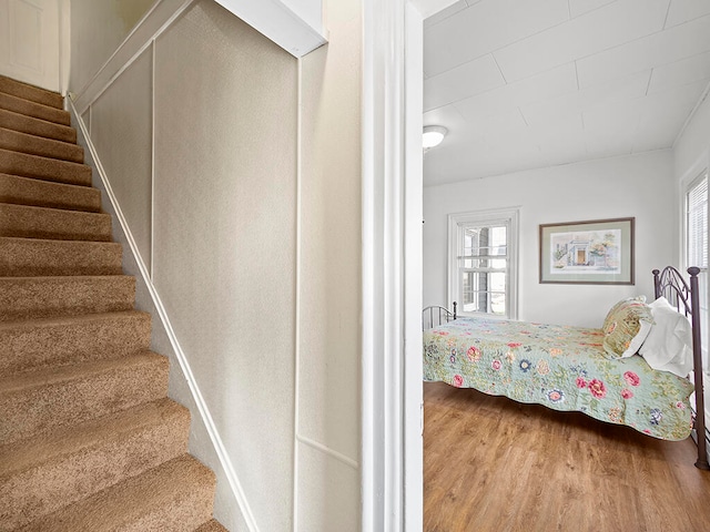 stairway featuring hardwood / wood-style floors and plenty of natural light