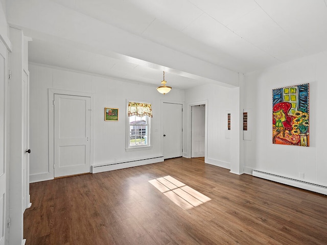 spare room with hardwood / wood-style flooring and baseboard heating