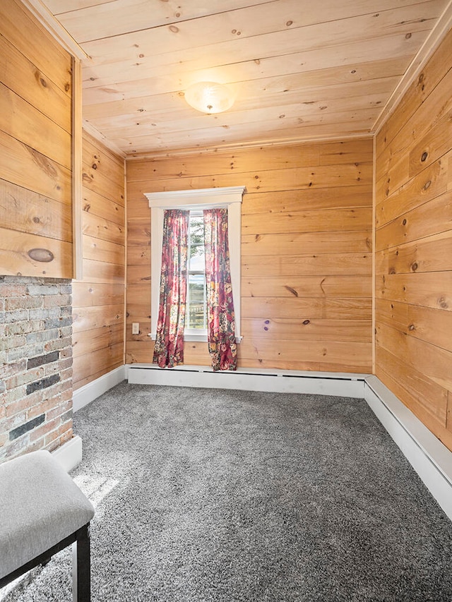 carpeted empty room featuring wood walls and wooden ceiling