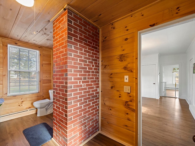 bathroom with baseboard heating, wood walls, wooden ceiling, and hardwood / wood-style flooring