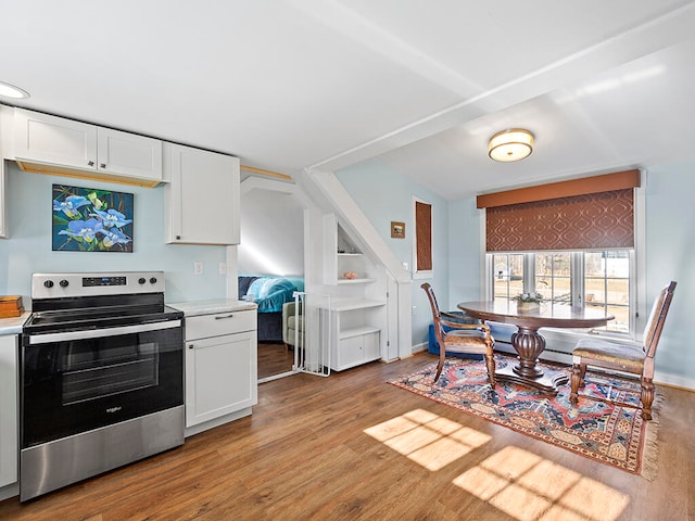 kitchen featuring white cabinets, light hardwood / wood-style floors, and stainless steel electric stove