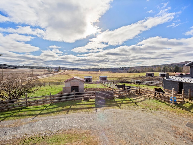 view of yard with an outbuilding and a rural view