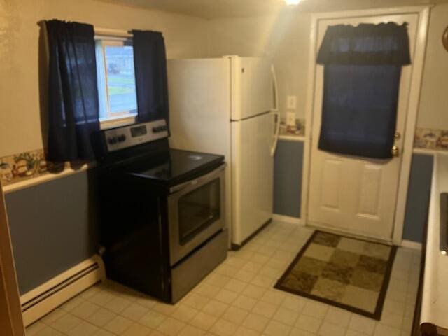 kitchen featuring white refrigerator, electric range, a baseboard heating unit, and light tile patterned floors